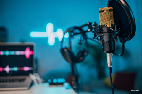 A headset hanging on a microphone in a blue room. Can I do voice over work from home?