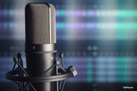 Close up of a microphone with computer screen in background 