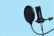 Microphone with a pop filter on a blue background Do I Need A Pop Filter For Voice Overs