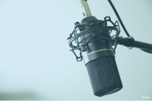 Close up of a black voice over microphone mounted on a shock mount