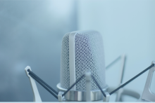 Close up of the top of a silver voice over microphone in a shock mount